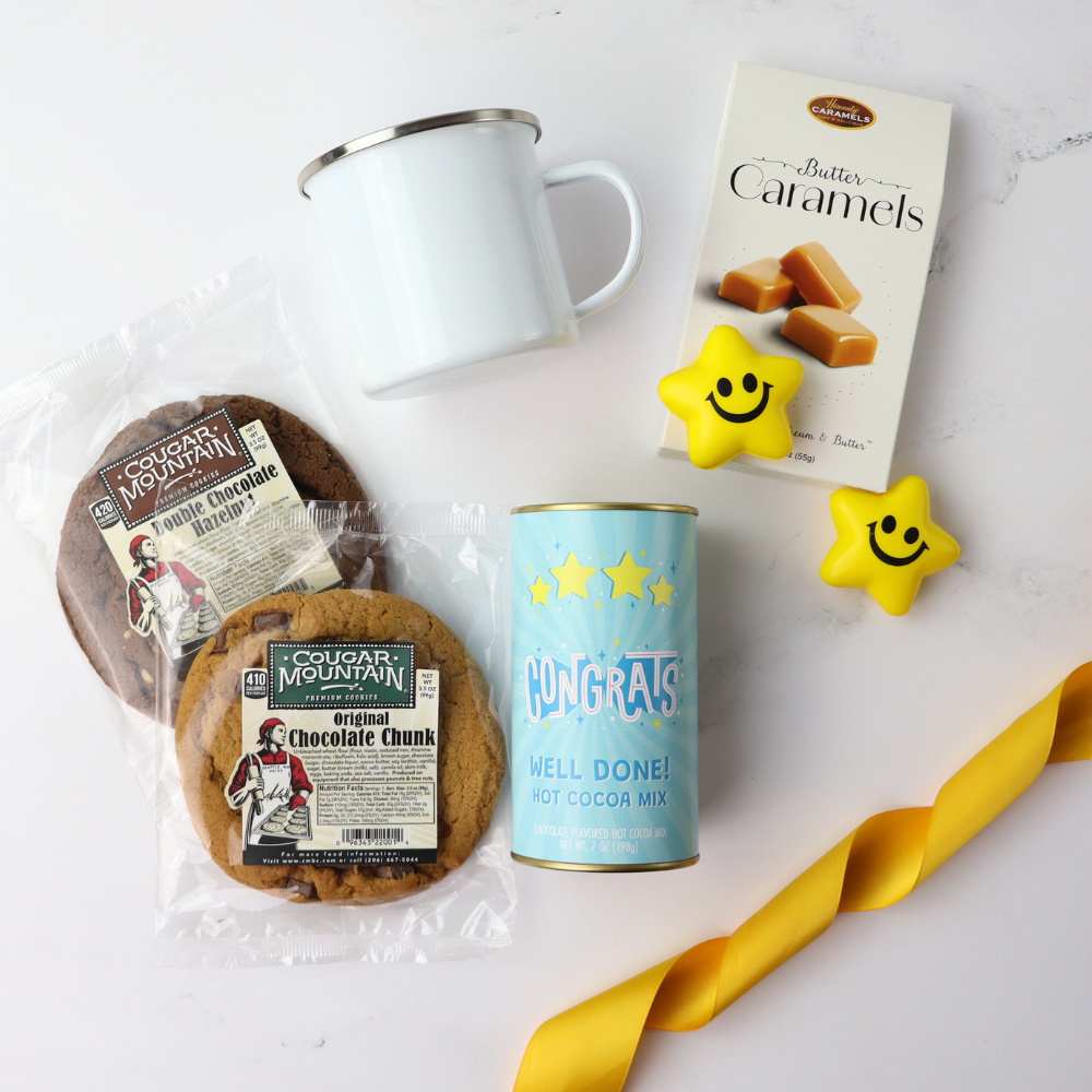 Assorted snacks including cookies, a mug, and a can of hot cocoa mix on a white surface.