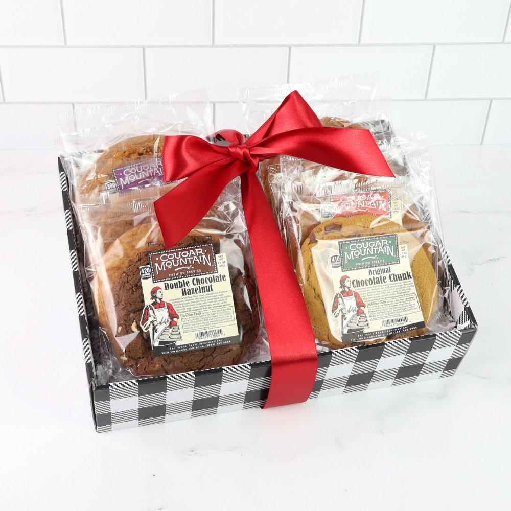 Gift set with soft baked cookiesin packaging tied with a red ribbon on a white background