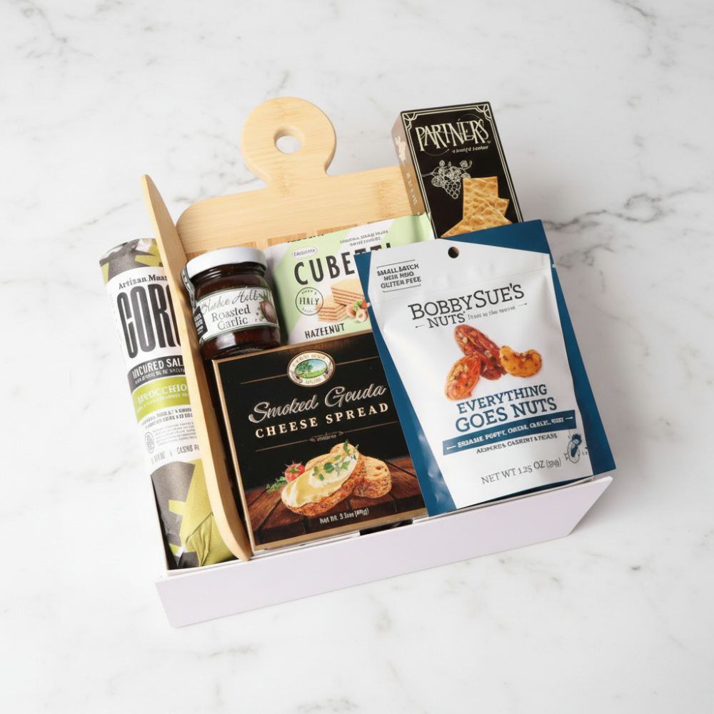 Gourmet gift basket with various food items on a marble surface