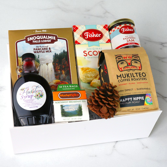 breakfast gift set with Seattle tea, pancake mix, hazelnut spread, jam, and nuts arranged neatly for gifting