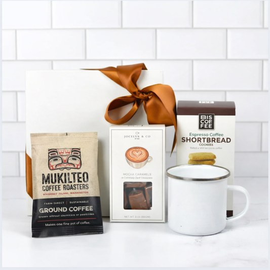 Coffee package, mug, and cookies on a white surface with a white tiled wall background