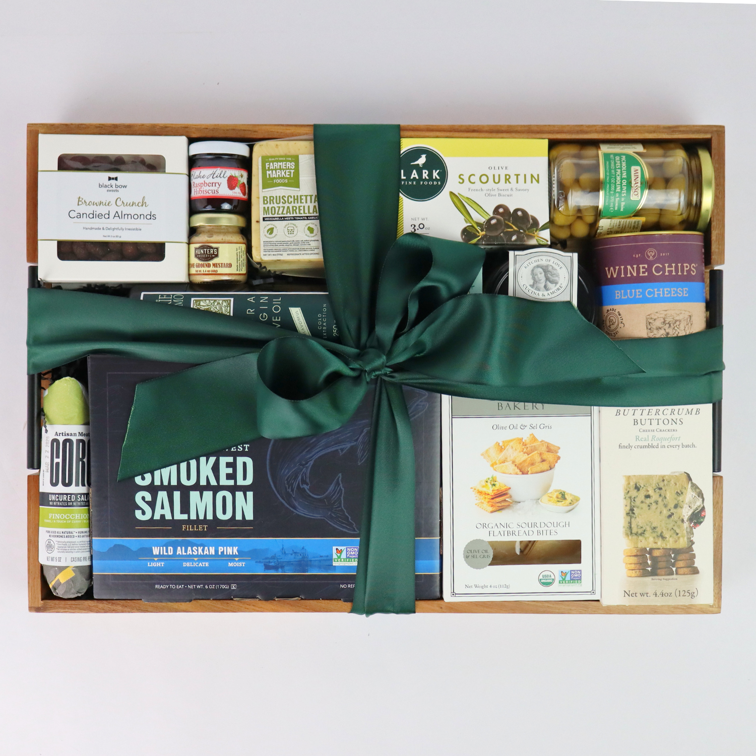 Gift basket with Pacific Northwest smoked salmon, chocolates, and gourmet snacks tied with a festive green bow – perfect Christmas or corporate gift.