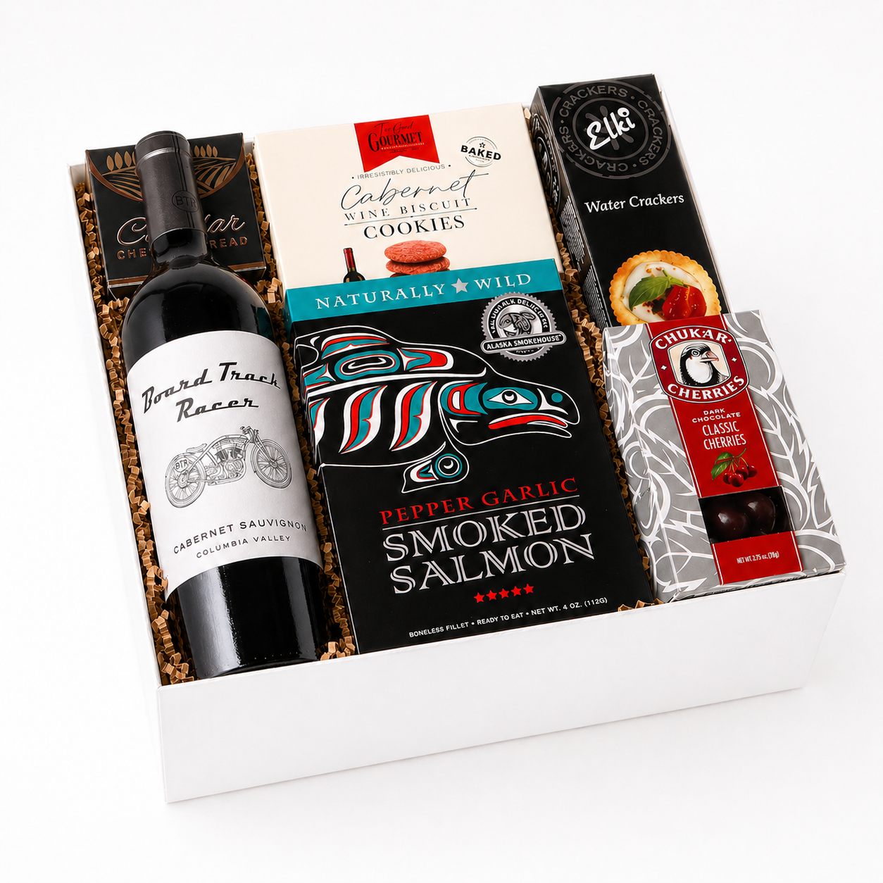 Gift basket with mark ryan wine, cookies, smoked salmon, and crackers on a marble surface
