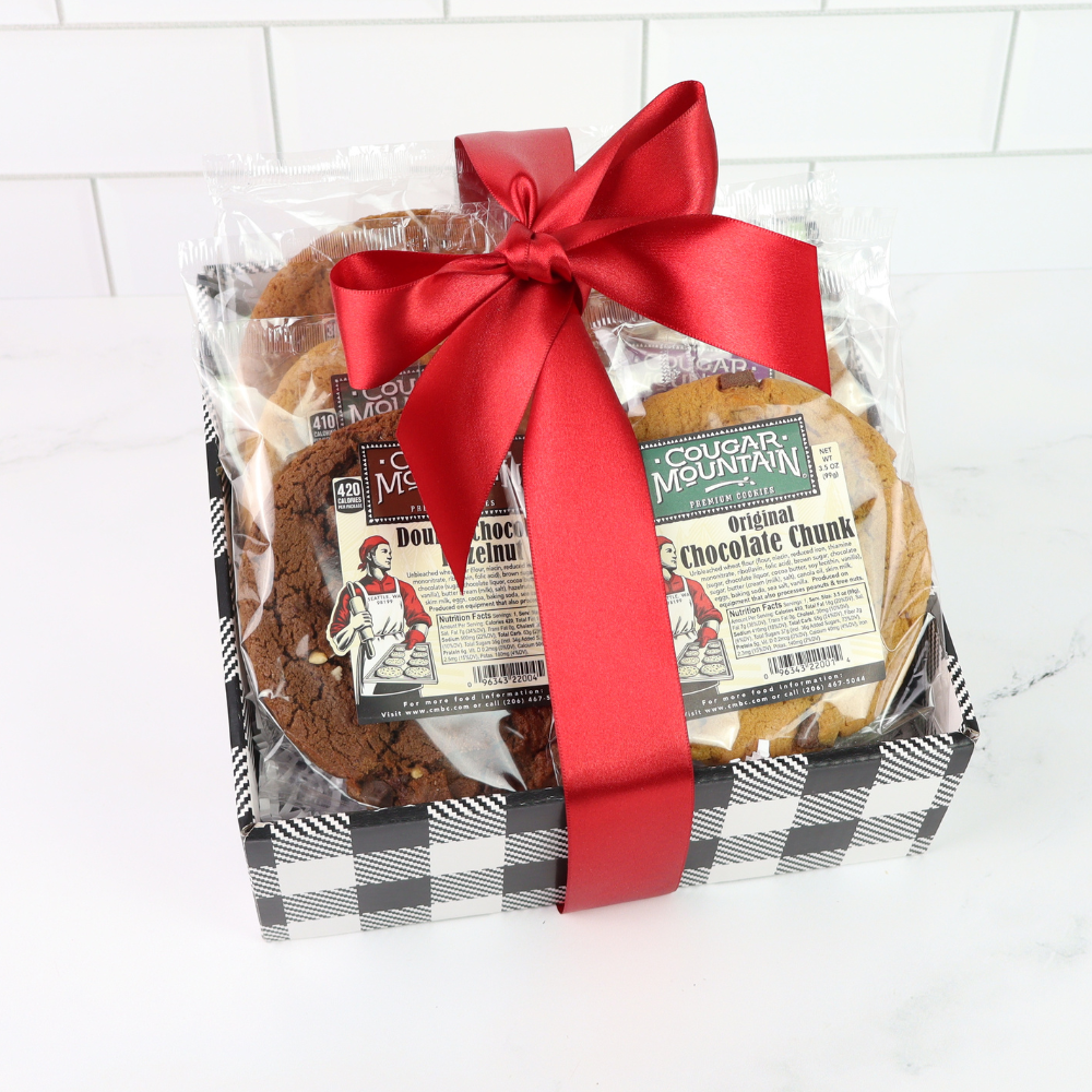 Packaged cookies with a red ribbon on a white tiled background