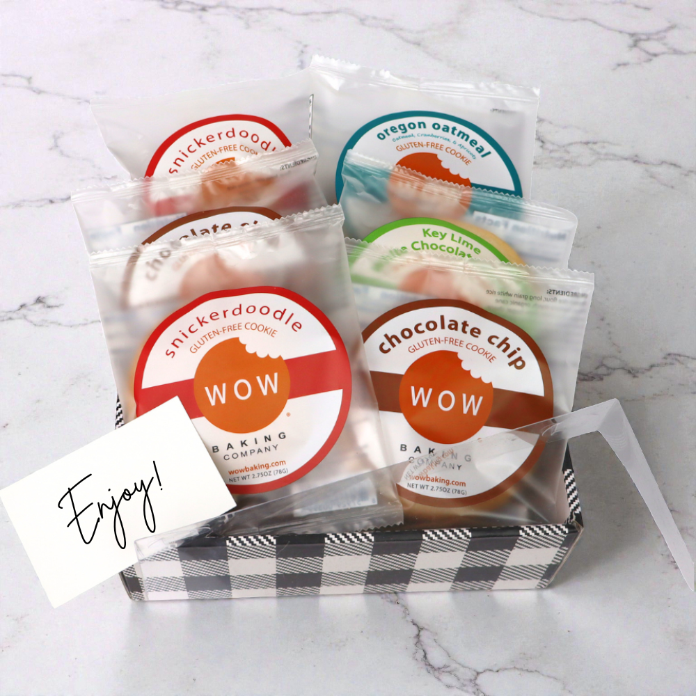 Assorted gluten free cookies by WOW Baking Company including chocolate chip, snickerdoodle, peanut butter, and key lime white chocolate in a clear lid gift tray