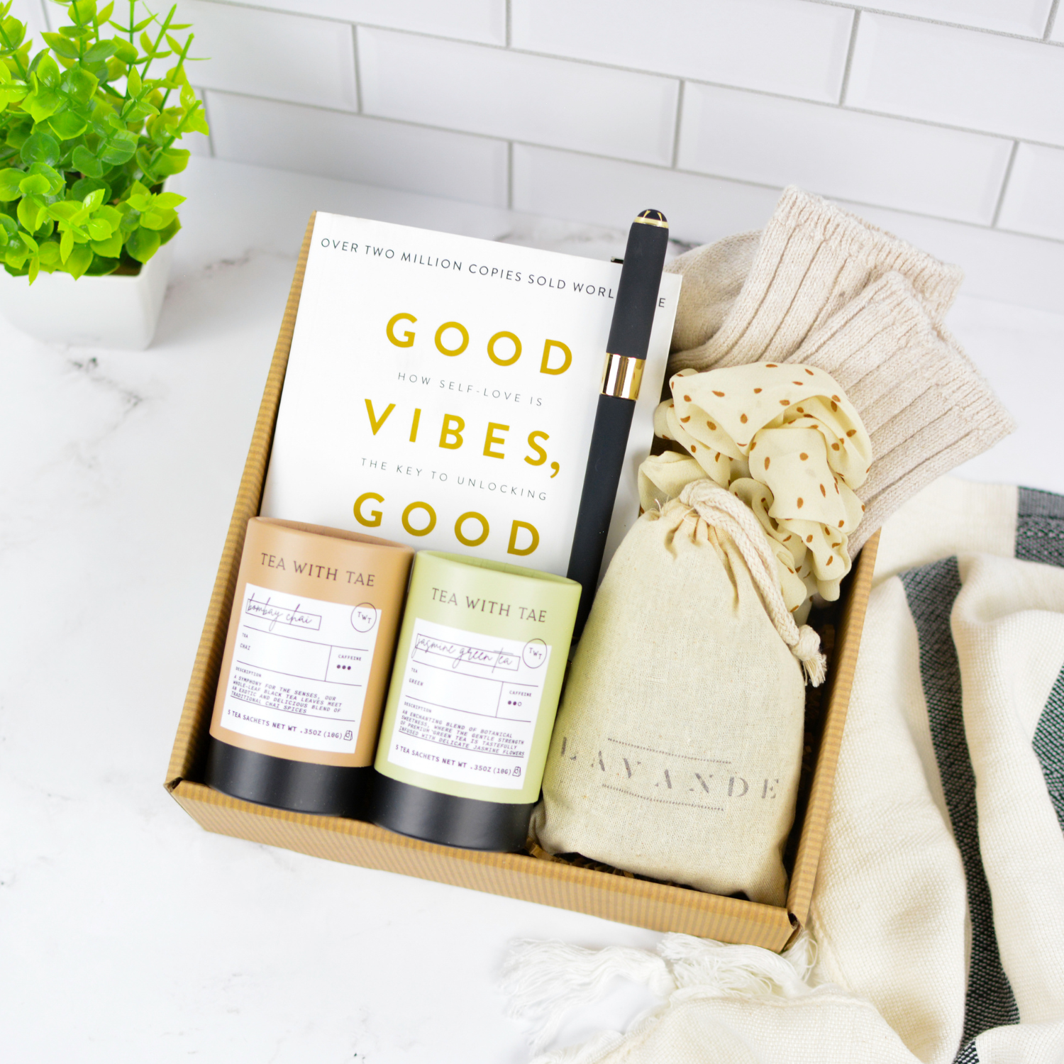 A relaxing self-care gift box featuring an inspiring book, premium teas, cozy socks, and calming accessories. Ideal for corporate gifting and wellness gifting.
