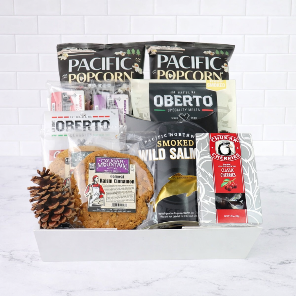 Assorted food items including popcorn, salmon, and cookies in a box on a white background