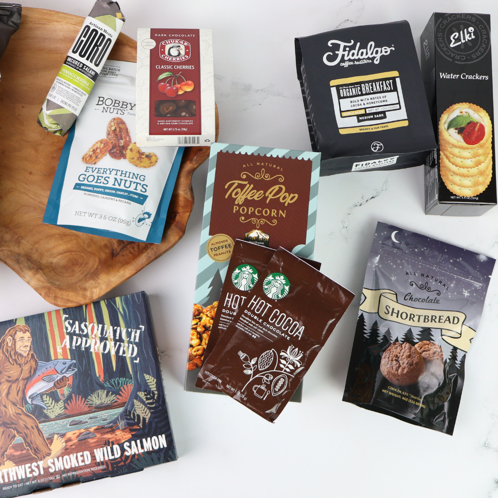 Assorted food products including snacks and coffee on a white surface