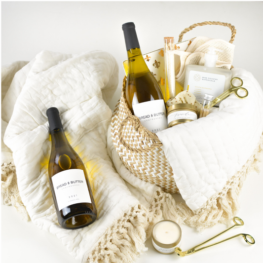 Luxury wine relaxation gift basket with chardonnay, throw blanket, candle, and spa accessories